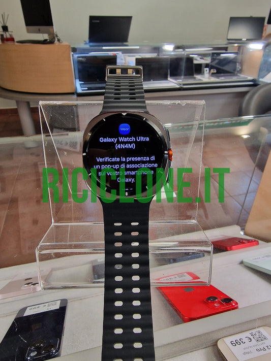 Samsung Galaxy Watch Ultra 47mm black smartwatch on stand showing Wear OS interface